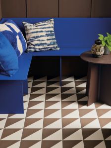 Semaphore Bahama 20 x 20cm Porcelain tile shown on the floor with Muddy Maddie painted wall and table and Azzurra Blue bench